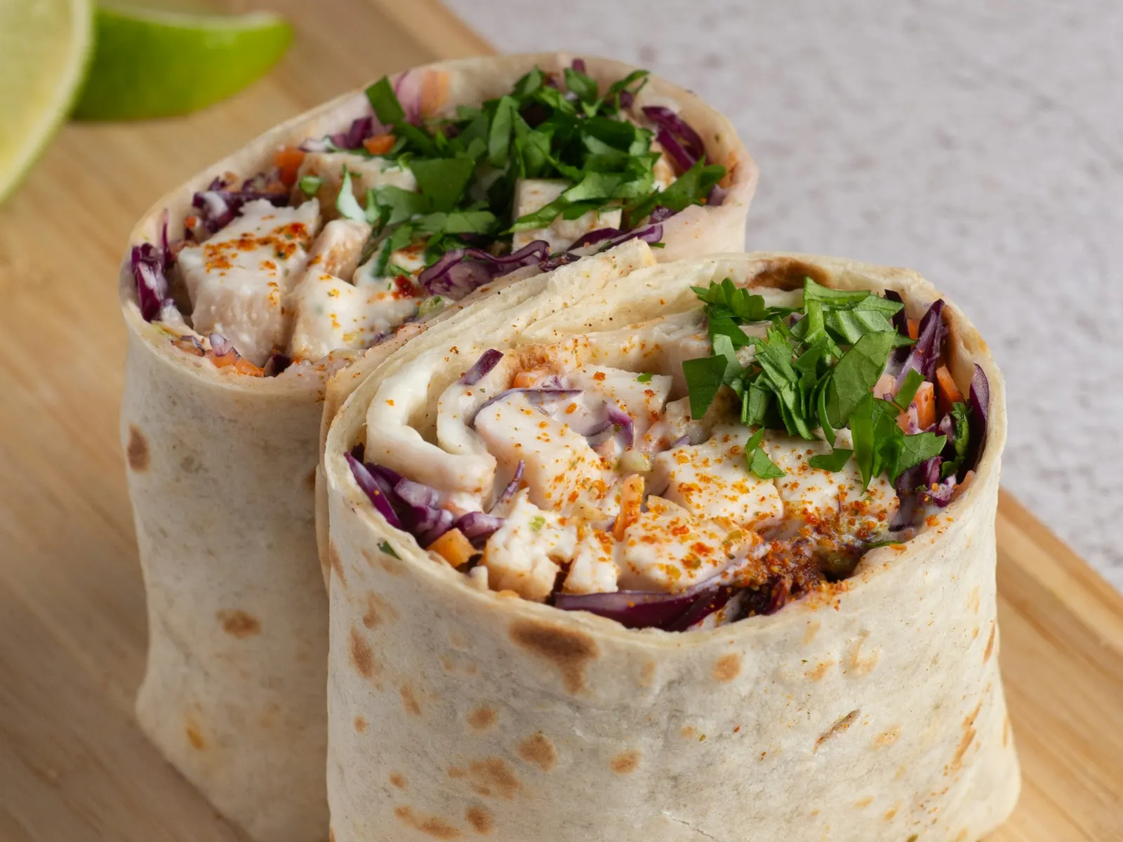 Chicken wraps cut in half showing the filling