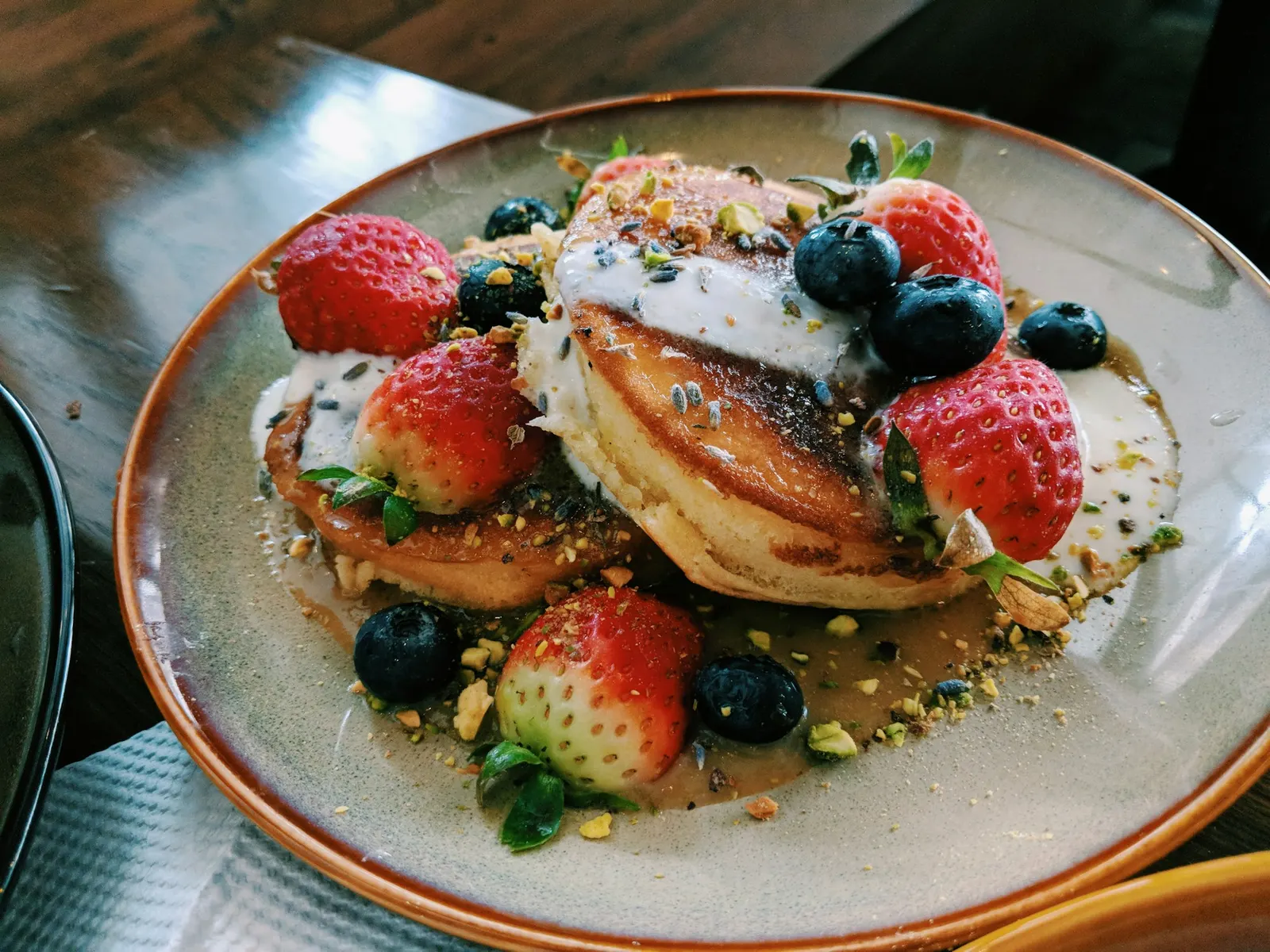 Stack of golden pancakes on a white plate