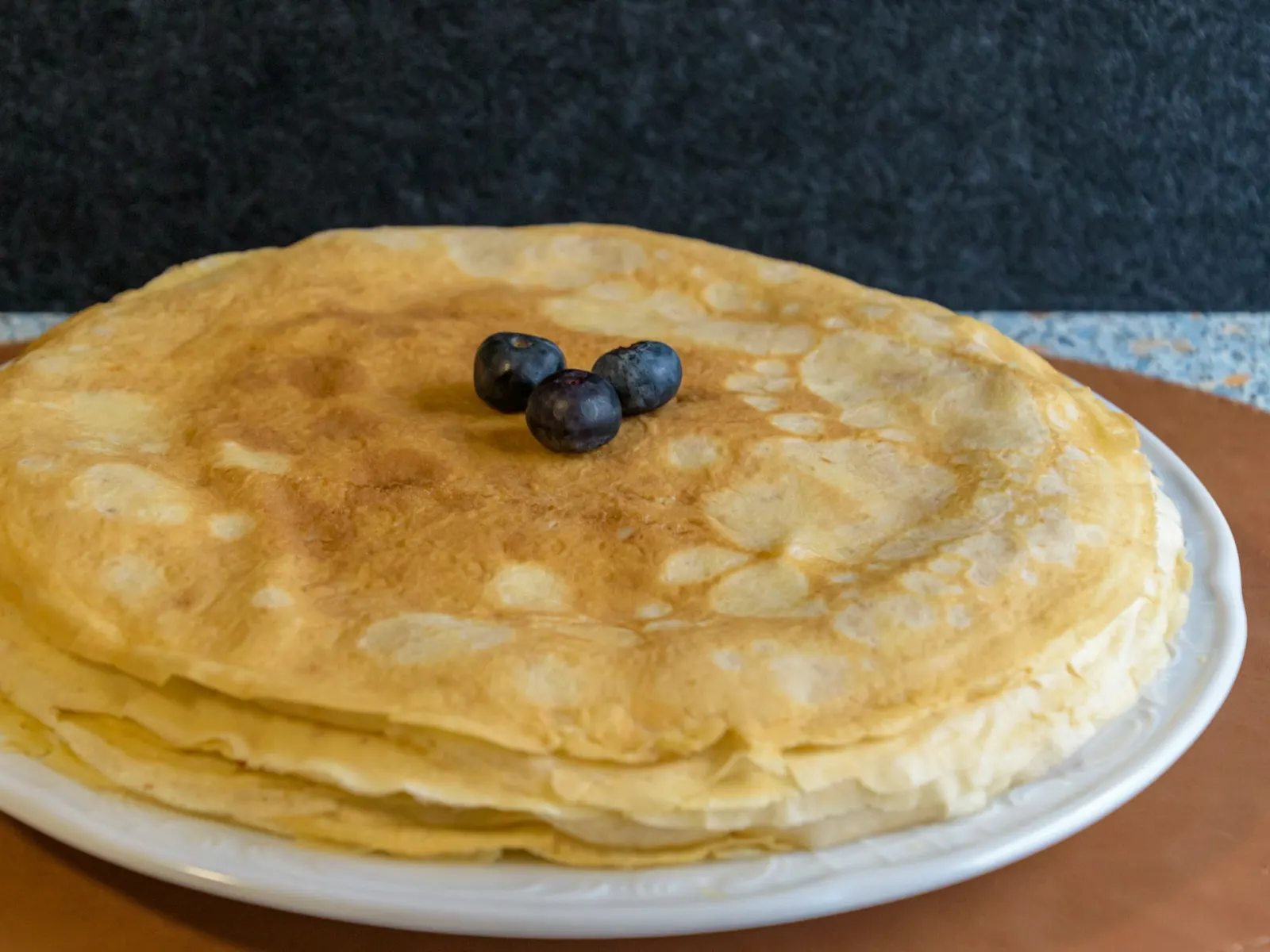Stack of thin protein crepes topped with blueberries