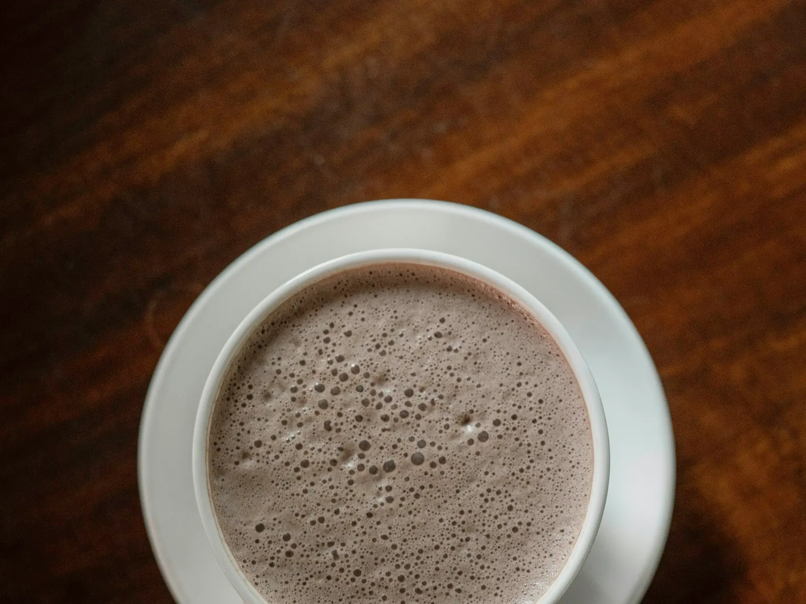 Mug of protein hot chocolate on a saucer