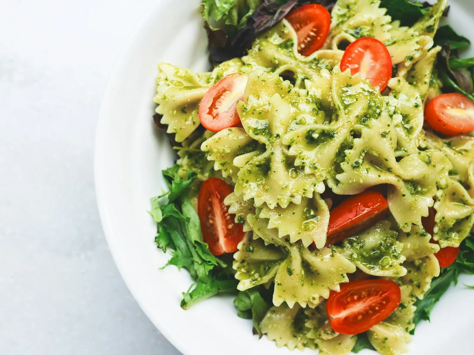 Protein pasta salad with tomatoes and greens